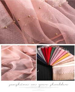 Detail of sheer pink scarf with shimmering metallic finish and gold beaded edges