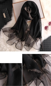 Detailed view of the sheer black scarf with gold glitter stripes and beaded edges
