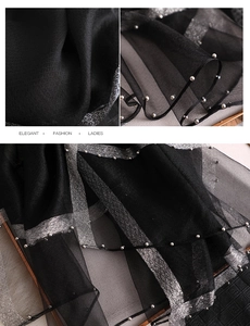 Detail of sheer black scarf with elegant silver glitter trim and delicate pearl beads