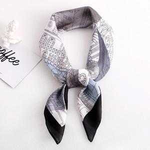 Détail d'un foulard en soie avec croquis d'architecture et nœud élégant stylisé