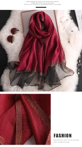 Detail of wine red silk scarf with gold lurex texture, mesh lace, and pearl beading