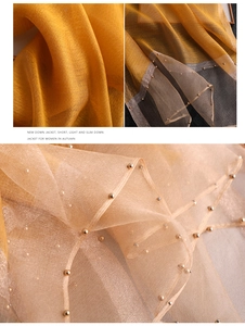 Detail of lightweight sheer scarf showing gold bead accents and fine textured fabric