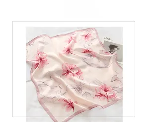 Detail of pink silk floral scarf with soft satin texture and elegant hand-rolled edges