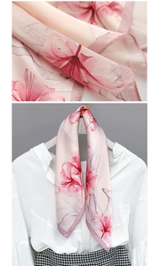 Detailed view of lightweight floral silk scarf with hand-rolled edges and lily print