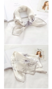 Detailed view of the tie-dye floral silk scarf with hand-rolled edges and satin finish