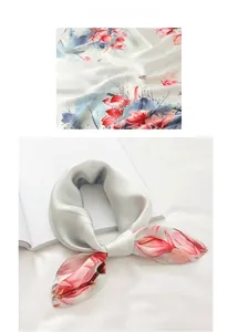 Detail of silk scarf showing pink magnolia prints and smooth satin fabric texture