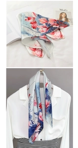 Detail showing floral silk scarf draped on a white shirt with elegant magnolia pattern