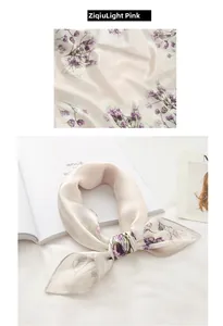 Detail of light pink faux silk scarf featuring purple lavender floral patterns and rolled edges