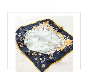 Detail of premium real silk scarf featuring blue borders and floral bird patterns