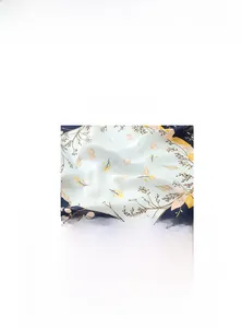 Detail of aqua blue silk scarf with elegant ocean theme seashells and floral prints
