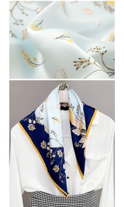 Close-up of silk scarf featuring vintage floral shell prints and blue satin texture