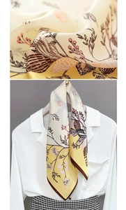 Close-up of vintage floral bird print on silk scarf with elegant satin texture