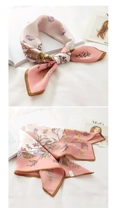 Detail of silk scarf with floral shell print and hand-rolled edges in a chic setup