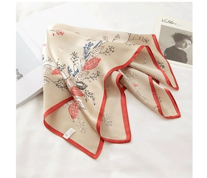 Detailed close-up of 53cm 100% mulberry silk scarf with floral prints and shells