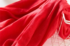 Close-up of bright red cotton linen scarf showing detailed woven fabric texture