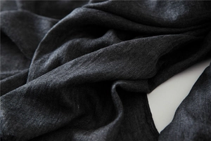 Macro view of dark grey cotton linen scarf showing soft woven texture and fabric details