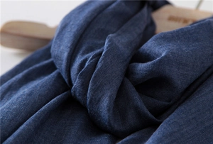 Close-up of deep blue linen-cotton scarf showing fine texture and knit details