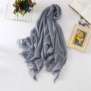 Light gray cotton linen scarf with frayed edges styled with vintage decor on white