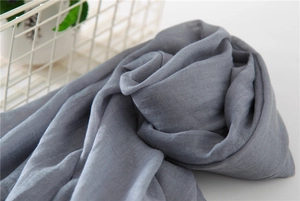 Close-up of grey cotton linen scarf showing natural fabric texture and lightweight weave