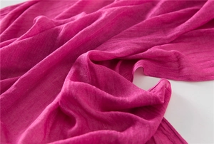 Detailed texture of rose pink cotton linen scarf with soft folds and breathable fabric weave