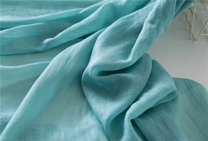 Close-up of lightweight linen cotton scarf in cyan with a natural breathable texture