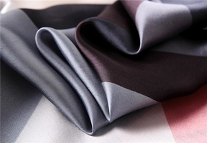 Macro shot of high-quality silk scarf fabric with elegant color blocks and smooth texture