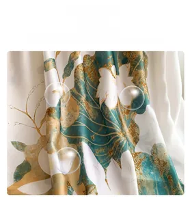 Detail of faux silk fabric featuring elegant lotus floral prints and smooth drape texture