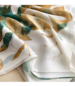 Detail of silk scarf showing lotus print texture and soft drape of the fabric
