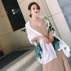 Elegant silk-like shawl featuring green lotus prints on a white base for sun protection