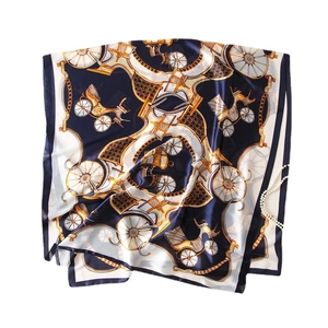 Elegant silk-like scarf with vintage carriage print and gold chains on blue background