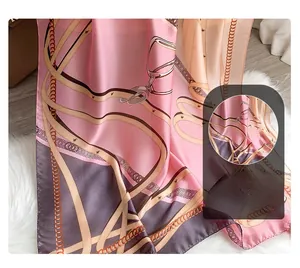 Detail of digital print chain pattern on soft silk scarf against white plush background