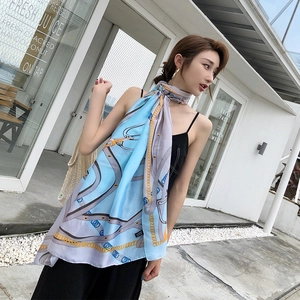 Detail of elegant chain pattern printed silk scarf with smooth draped texture in sunlight