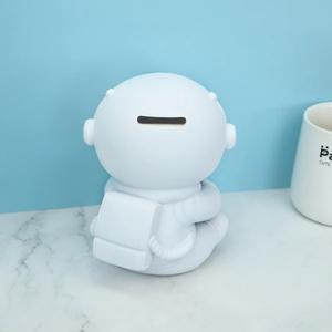 White astronaut piggy bank for boys, durable vinyl space figure with coin slot on back