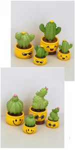 Detailed close-up of cute cactus dashboard ornaments with various funny emoji faces