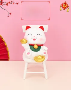Lucky Cat figurine on white chair with gold ingots and festive oriental background
