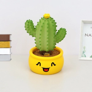Smiling cactus bobblehead with yellow flower on spring base for car and desk decor