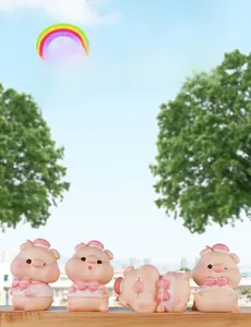 Set of four cute pink resin piglets in sailor outfits displayed on a wooden fence