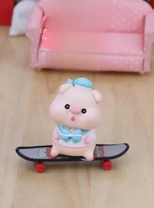 Cute pink pig figurine on a skateboard for car dashboard and desk decor