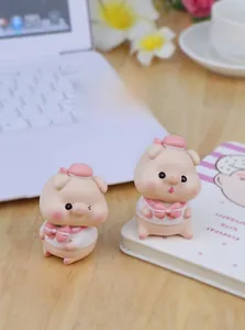 Close-up of cute resin pig figurines in sailor outfits for desktop or car decor