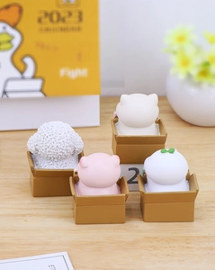 Set of four cute cartoon animals sitting in miniature cardboard boxes for desk decor