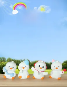 Close-up of four cute resin duck figurines with various accessories on green grass