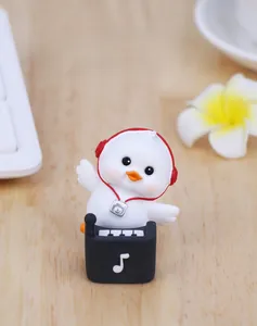 Close-up of a cute white hip-hop duck figurine with red headphones and silver camera