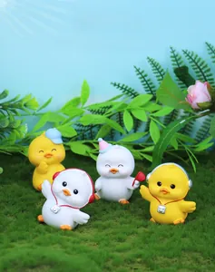 Close-up of four cute resin ducks with colorful hats and accessories on moss grass