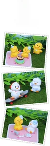 Close-up of cute miniature resin ducks with skateboards and headsets for desk decor