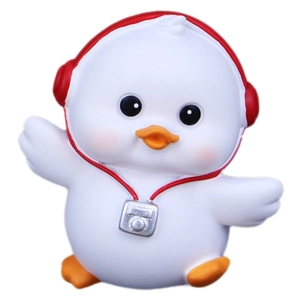 Cute white resin duck figurine with red headphones and silver camera on a white background
