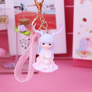 Cute cartoon deer girl keychain with pink hair and white bear on a pink background