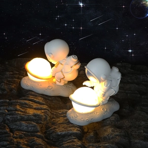 Astronaut night light creative lamp with glowing planet orb on moon base decor