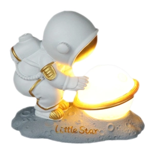 Astronaut night light with glowing planet on lunar base featuring Little Star text
