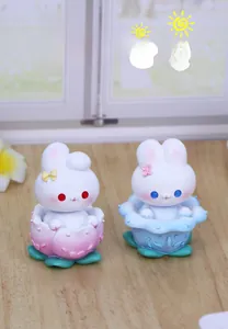 Close-up of cute rabbit car ornaments with flower headbands and lotus bases