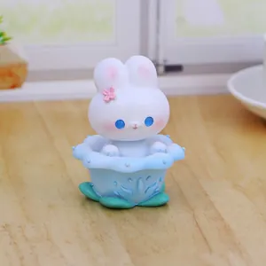 Cute resin shaking head rabbit car ornament with flower base for dashboard and desk decoration